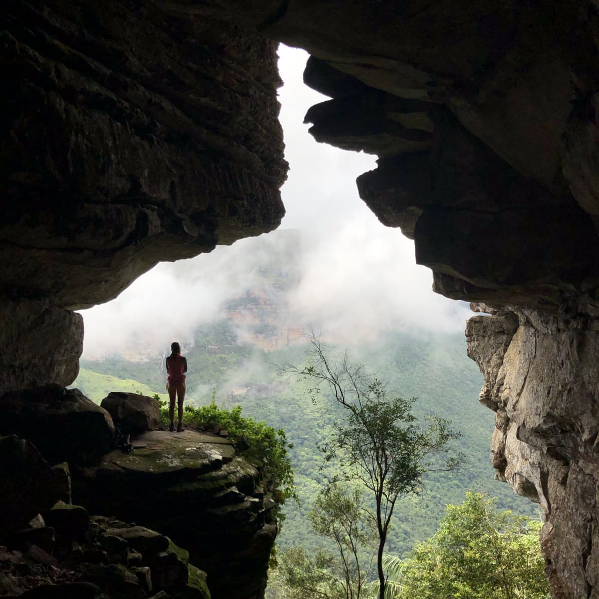 Solo traveller Fernanda resting beside a waterfall in Chapada Diamantina