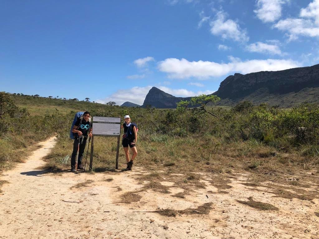 Fernanda hiking solo along a scenic trail in Chapada Diamantina at sunset