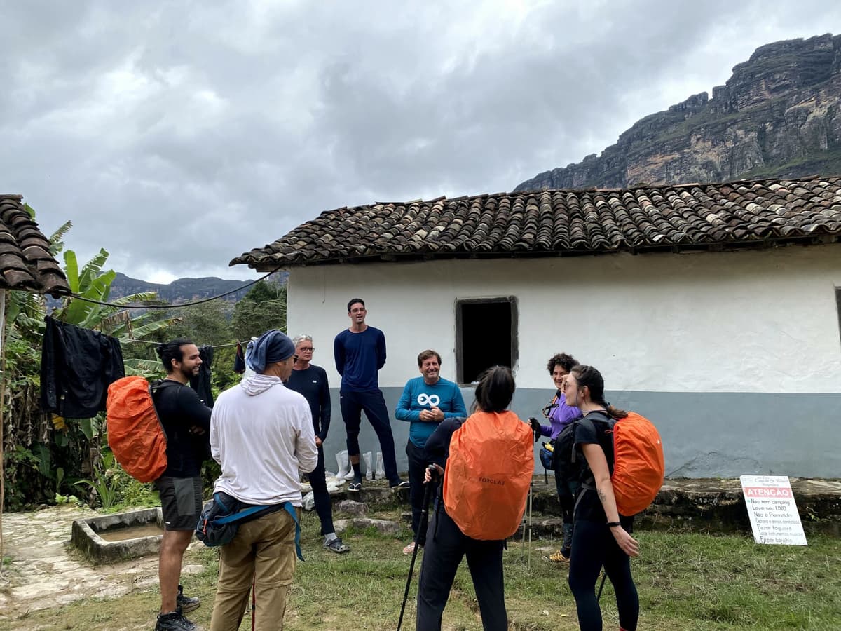 Adventurers hiking across the green hills of Vale do Pati