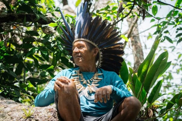 Local guide showing visitors the living Amazon forest
