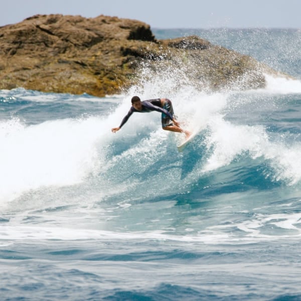 A surfer riding a wave off the coast of Itacaré, Bahia, Brazil.