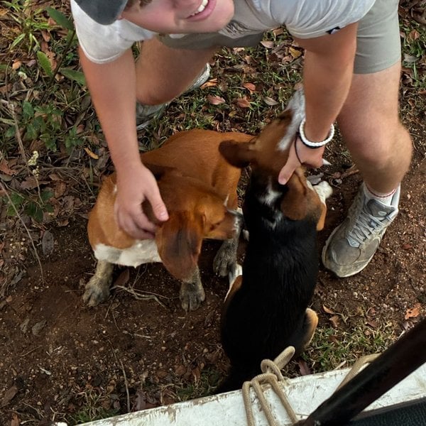 Sally's son petting the ranch dogs