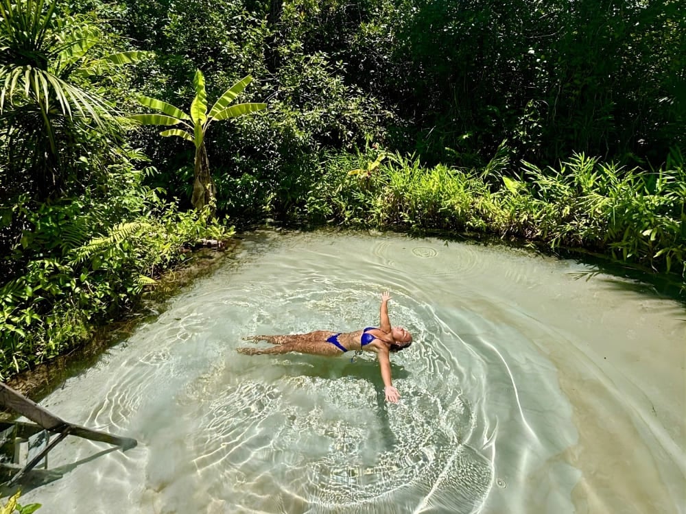 Female traveler floating peacefully in the crystal-clear waters of a fervedouro natural spring in Jalapão, Brazil. Female traveler floating peacefully in the crystal-clear waters of a fervedouro natural spring in Jalapão, Brazil.