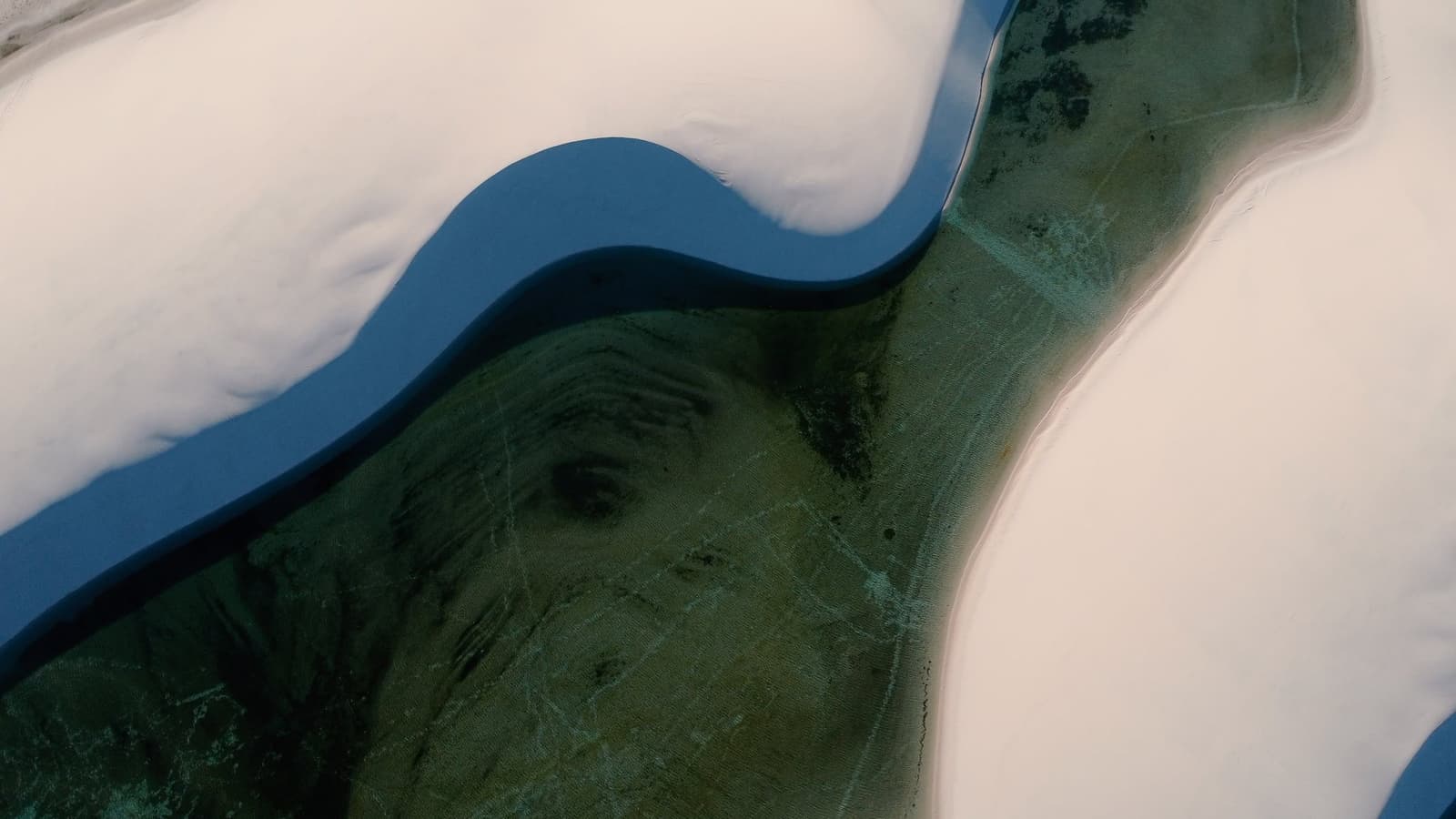 From above, the dunes look like they're slowly swallowing the water whole. Photo 5