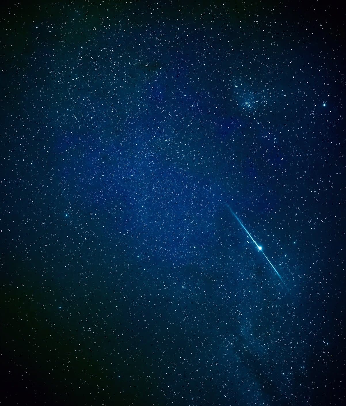 One streak of light, and suddenly everyone on deck goes quiet. A bright shooting star streaks diagonally across a deep blue star-filled sky on an Amazon Cruise Trip in Brazil, with thousands of stars and the Milky Way visible overhead