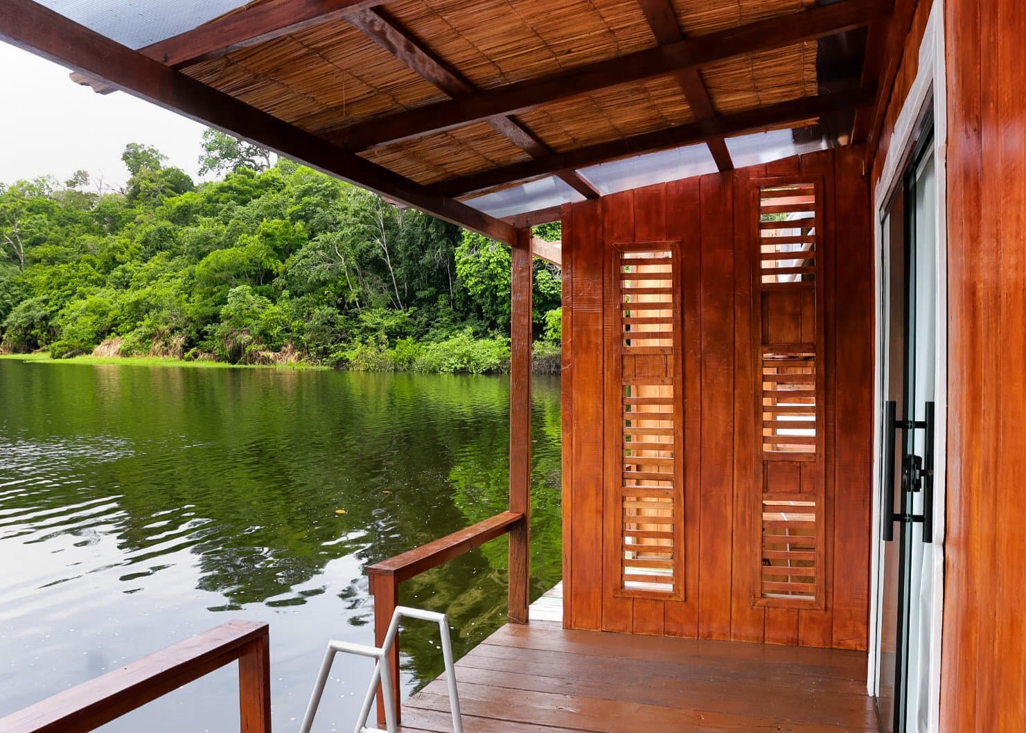 Still water, deep green canopy — your private deck at the edge of the Amazon. Photo 5