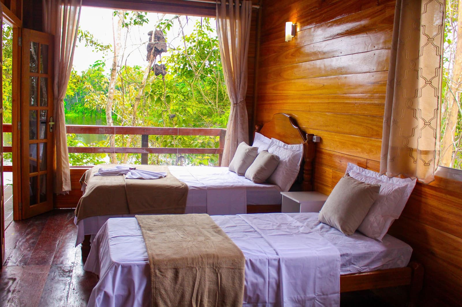 Rustic hardwood walls, fresh linens, and the rainforest right outside your door. Photo 2