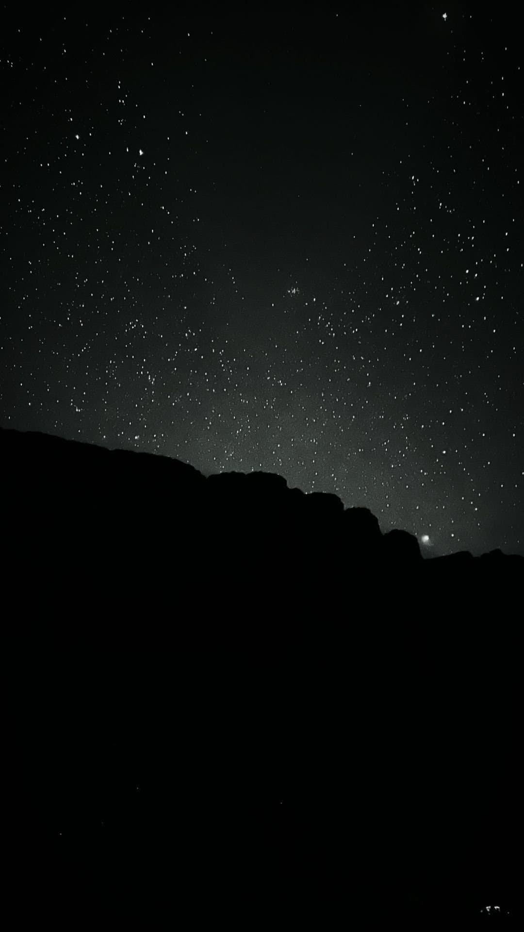 No city lights, no filter, just the sky doing its thing. A dense field of stars fills the dark sky above the jagged silhouette of a rocky ridge on the Mount Roraima hike