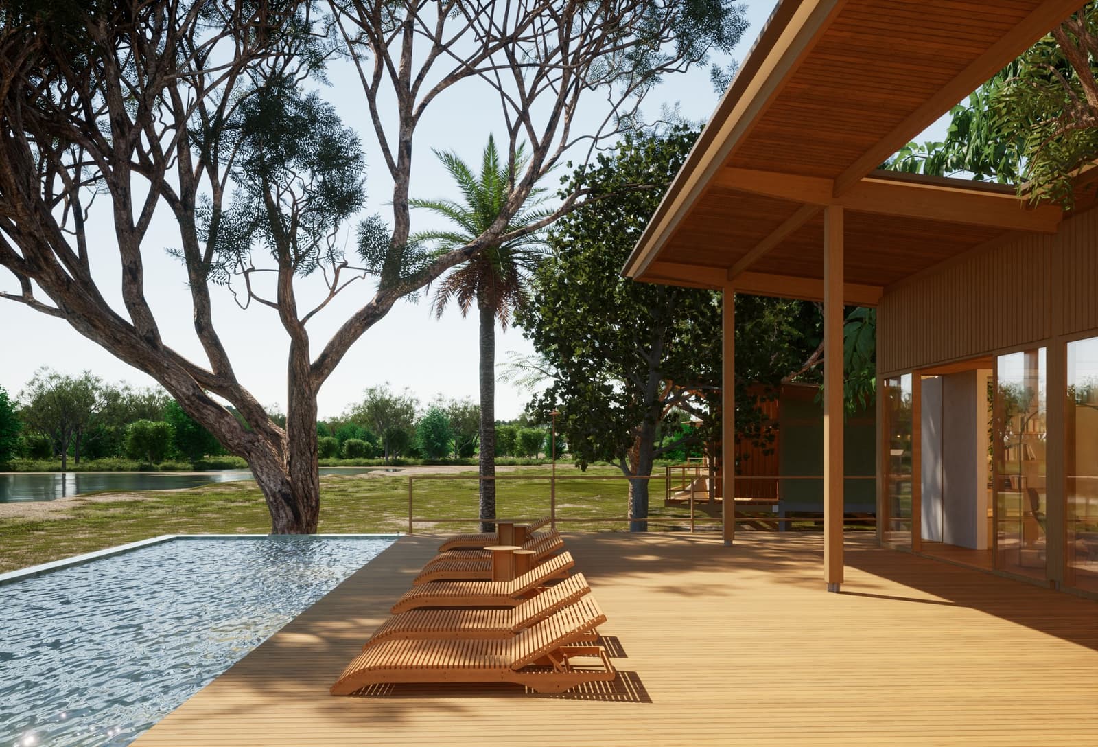 After a morning on safari, this deck earns every second of your afternoon. Teak sun loungers lined up on a timber pool deck beside a calm infinity pool, with native trees and a waterway stretching into the distance at a pantanal luxury safari ecolodge