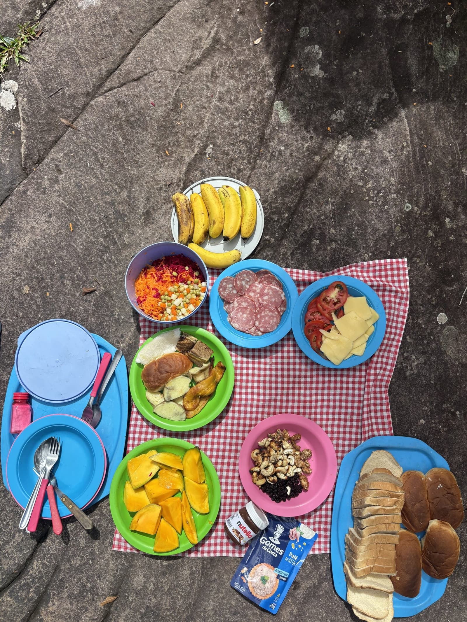 Lunch on a rock beats any restaurant table, full stop. Colourful plates of fruit, salami, cheese, grated vegetables, nuts and sliced bread laid out on a red-and-white checked cloth on a rock during a Pati Valley hike picnic lunch