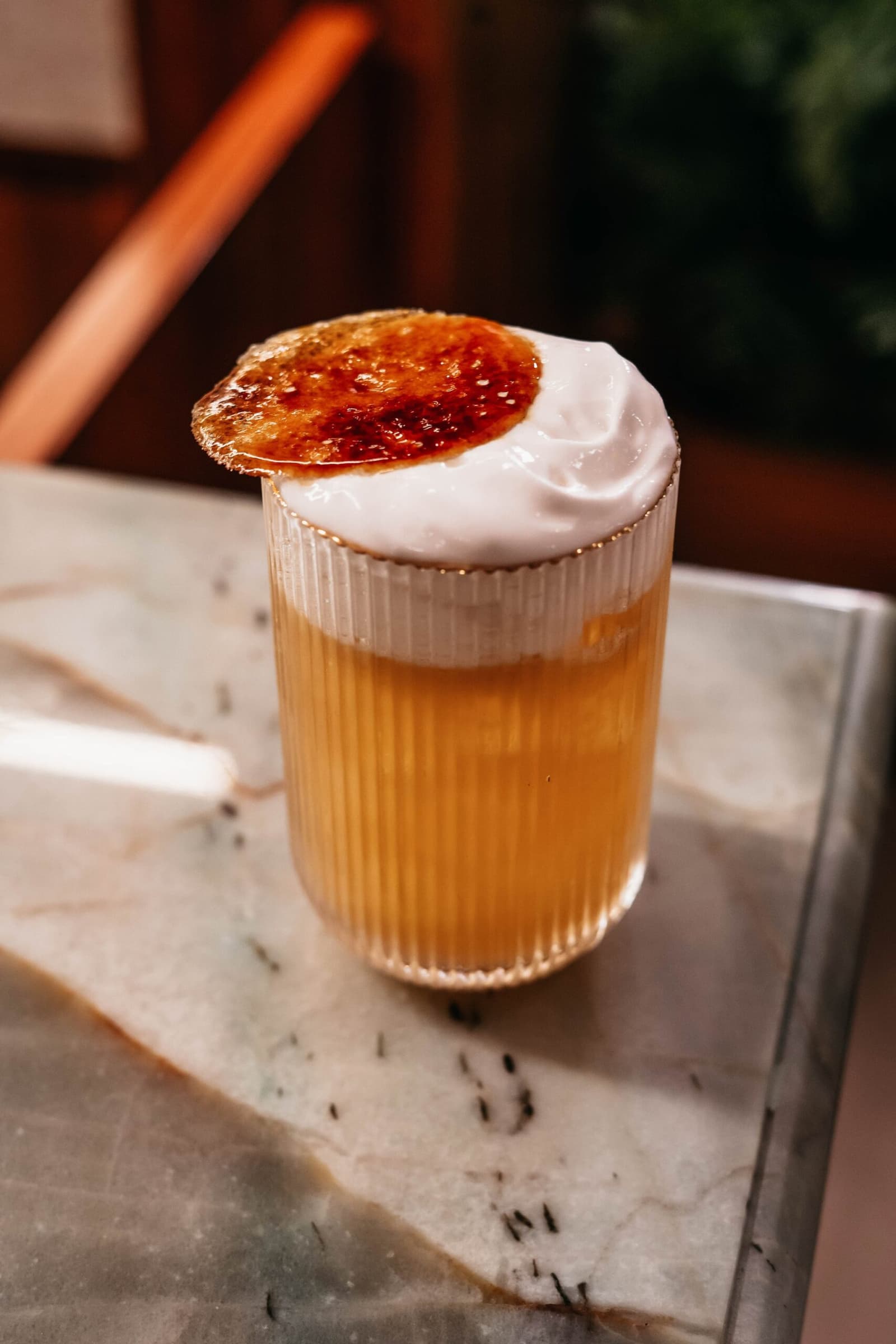 The bar on board has clearly been paying attention. A ribbed glass filled with an amber cocktail, topped with thick white foam and a caramelised brûléed disc, served aboard the untamed amazon cruise