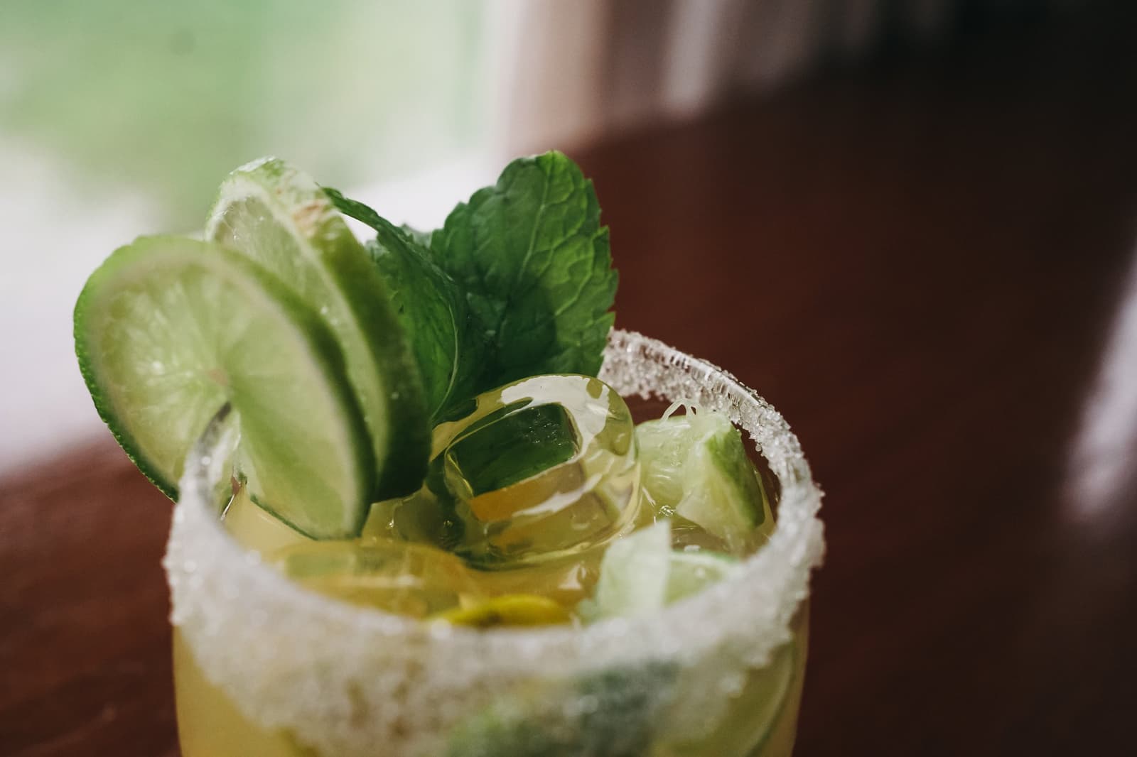 Sundowner sorted. The river can wait five more minutes. A sugar-rimmed glass garnished with cucumber slices, lime wedges and fresh mint leaves, served on the untamed amazon cruise