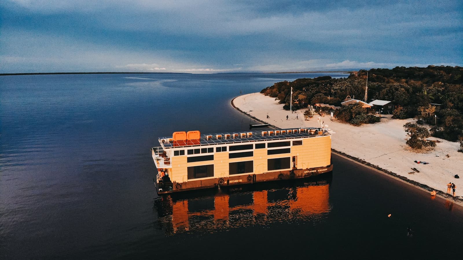 Your floating base camp, parked exactly where the forest meets the sand. Photo 1