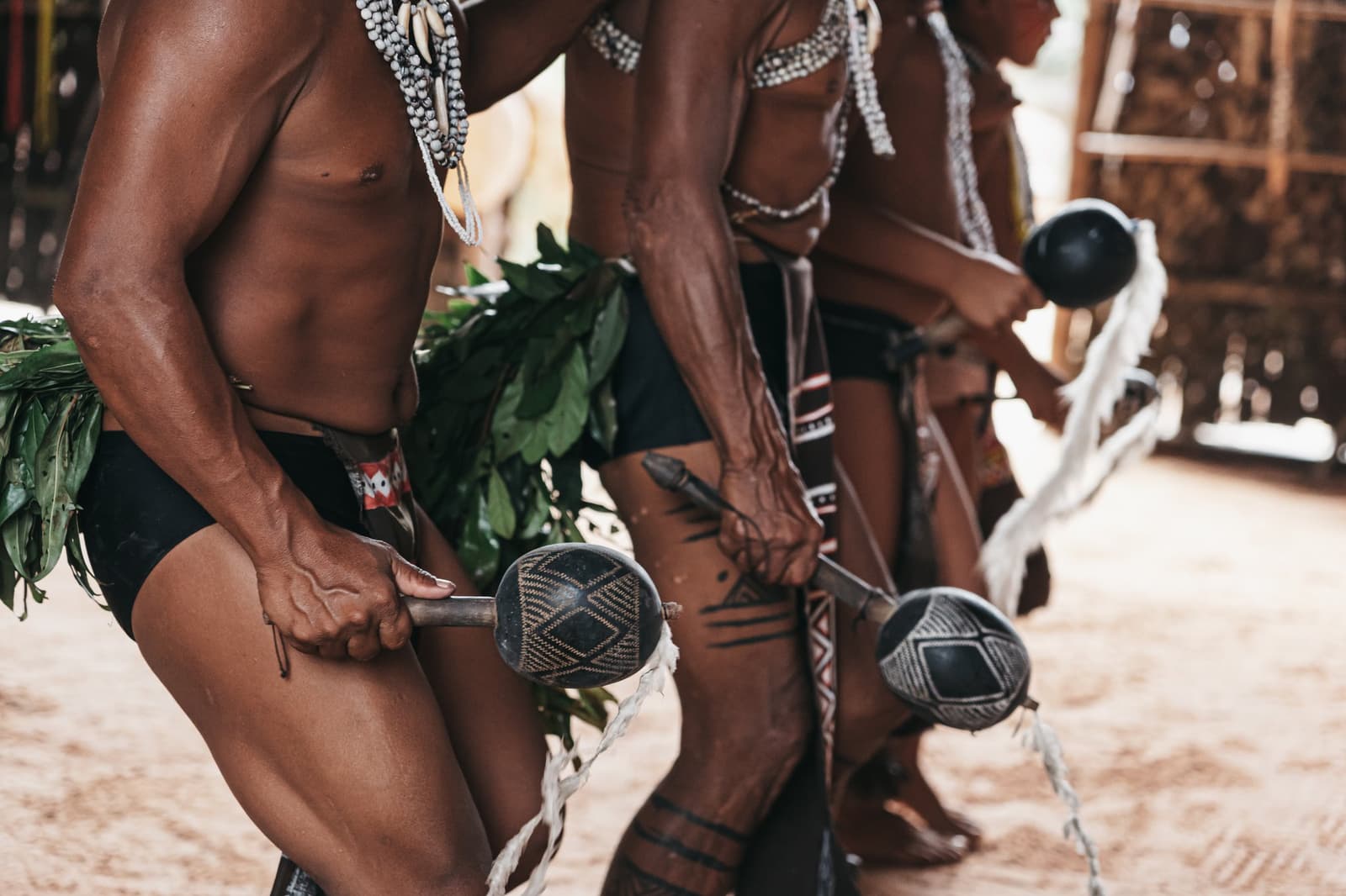 The rattles, the body paint, the sand underfoot, culture passed down without a single written word. Photo 1
