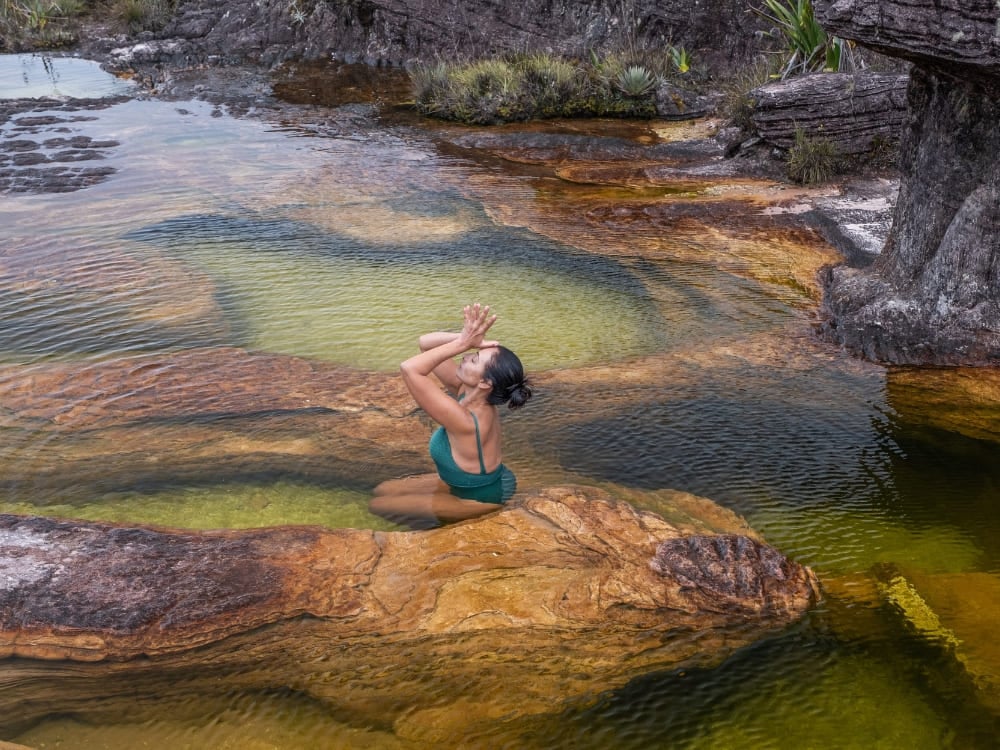 A trekker swimming in a natural jacuzzi pool on Mount Roraima A trekker swimming in a natural jacuzzi pool on Mount Roraima