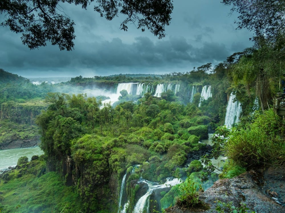 Iguazu Falls seen from a forest viewpoint under heavy rainy-season storm clouds, Brazil. Iguazu Falls seen from a forest viewpoint under heavy rainy-season storm clouds, Brazil.