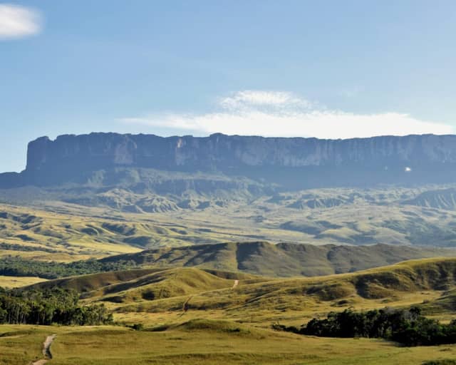 Mount Roraima's flat-topped tepui rising above the green Gran Sabana savanna in Venezuela
