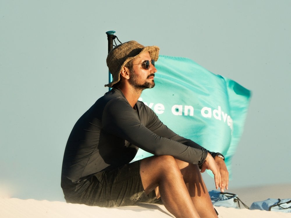 For Portuguese traveler Diogo Melo, the best part of the trip is witnessing the positive and direct impact that tourism has on the stability of host families. (Credit: Isadora Sá) Portuguese traveler Diogo Melo resting on a dune in Lençóis Maranhenses