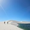 Friends walking at the lagoon in Lencois Maranhenses