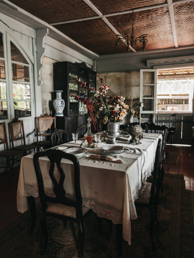 A historic dining room table set inside the Seringal Museum, representing the rubber boom era in the state of Amazonas.