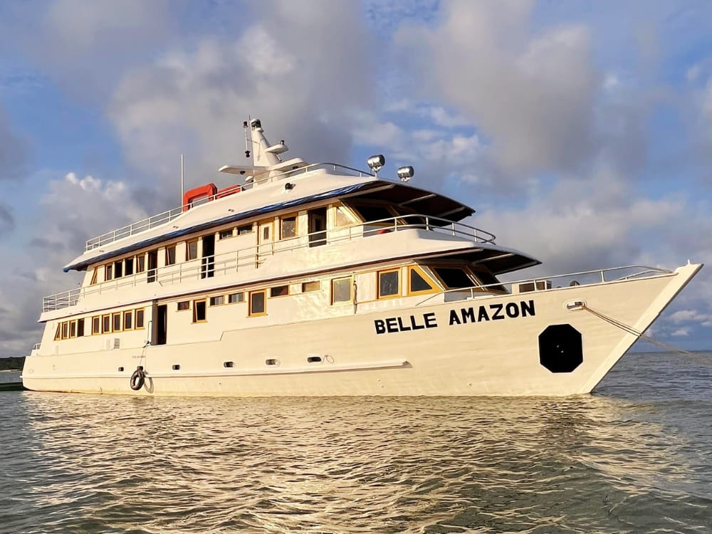 The Belle Amazon white riverboat sailing on the water, part of the Kaiara fleet offering cruises from Belém and Alter do Chão.