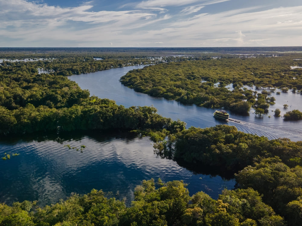 Vista aérea de um rio azul sinuoso fluindo através da exuberante Floresta Amazônica verde perto de Manaus. Vista aérea de um rio azul sinuoso fluindo através da exuberante Floresta Amazônica verde perto de Manaus.