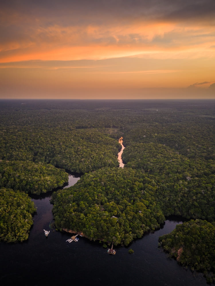 Aerial view of a tourist exploring the Anavilhanas National Park archipelago near a luxury Amazon jungle hotel