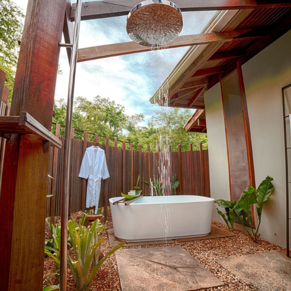 A luxurious outdoor bathtub and shower surrounded by nature at Cristalino Lodge, offering a high-end Amazon rainforest lodge experience.