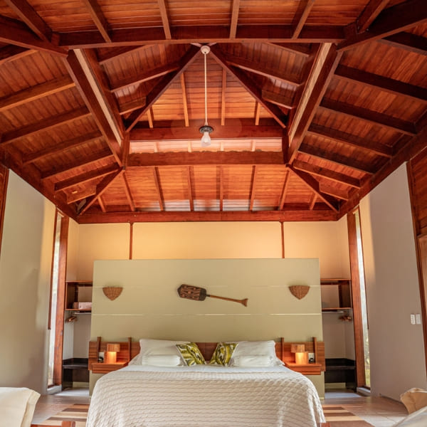 A spacious and sophisticated bungalow bedroom with a wooden ceiling at Cristalino Lodge in the Brazilian Amazon.