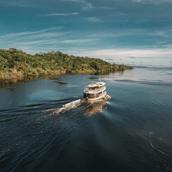Amazon river cruise boat navigating the calm waters, offering a unique way to explore the Rio Negro and Solimões rivers in comfort.